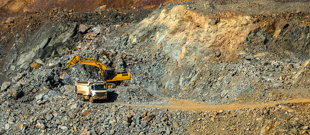 excavator loading a dump truck at a copper mine
